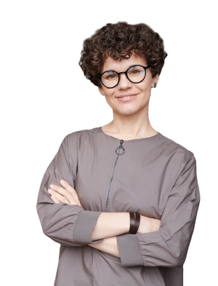 a woman with curly hair wearing glasses and a grey shirt